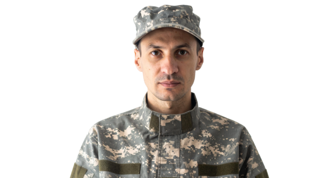 A stoic soldier in uniform, ready to serve his country. He is wearing a cap and looking straight to camera