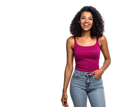 Joyful young woman with dark curly hair laughing wearing a magenta tank top and blue jeans posing with her hand in her pocket.