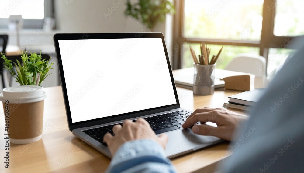 Poster a person working on a laptop computer. with a bright screen display, suggesting work in a office set