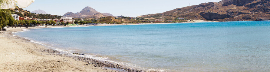 Fototapeta premium Panoramic View of a Sandy Beach and Turquoise Sea in Crete, Greece