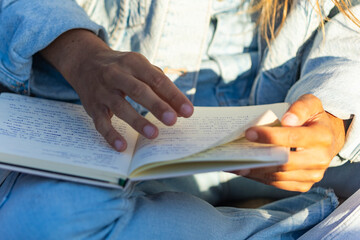 Woman reading notes in a notebook during a spiritual retreat on the beach