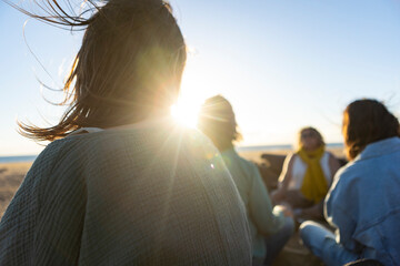 Women meditating together at the beach during a spiritual retreat