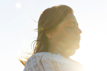 Woman meditating on beach at end of spiritual retreat