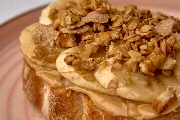 Deliciously Crafted Toast Topped with Sliced Bananas, Crunchy Granola, and a Drizzle of Sweet Syrup, Perfect for a Healthy Breakfast or Snack