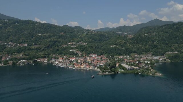 Wide Aerial Shot of Pella, Lake Orta, Italy &ndash; Scenic Village with Boat Approaching the Harbor