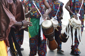 African folk dancers playing music in the street
