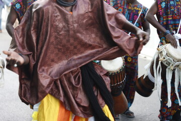 African folk dancers playing music in the street

