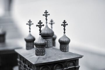 Obraz premium Intricate metal model of russian church domes in soft light. Styled crosses adorn top, evoking spiritual essence. Monochrome setting enhances architectural details