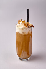 Deliciously Creamy Iced Coffee Beverage Topped with Whipped Cream and Garnished with Crispy Chips...