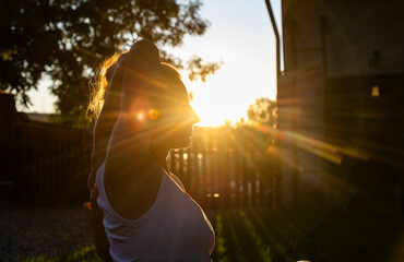 woman doing yoga at sunset outdoors