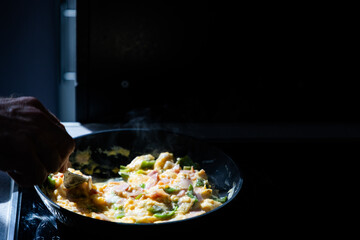 preparing scrambled eggs in the morning
