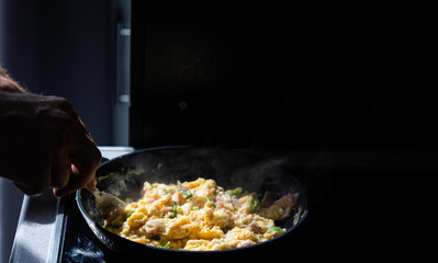 preparing scrambled eggs in the morning