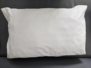 Soft white head pillow on the bed