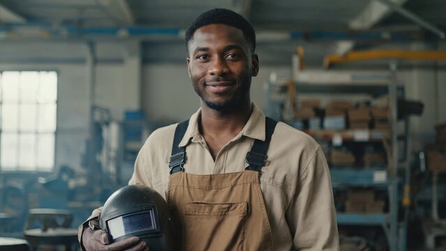 portrait of a smiling welder with helmet