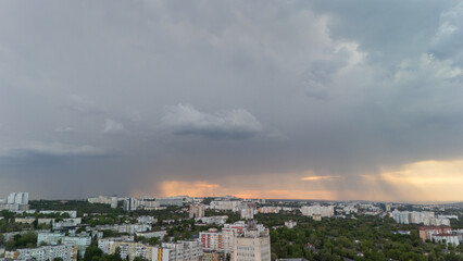 Aerial city view with residential buildings under stormy sky