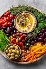 Food+and+beverage vibrant platter filled with fresh vegetables, olives, and creamy hummus creates delightful food and beverage experience