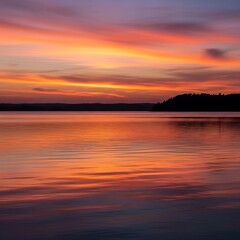 Obraz premium Serene sunset over a still lake.