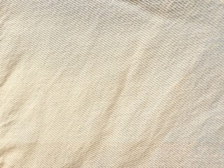  beige herringbone woven fabric texture with soft diagonal folds ideal for upholstery cushion covers or fashion textiles