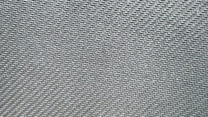  close-up of silver gray carbon fiber texture with diagonal woven pattern ideal for tech...