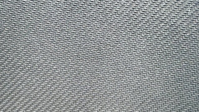  close-up of silver gray carbon fiber texture with diagonal woven pattern ideal for tech backgrounds and product mockups