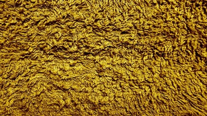 golden curly shaggy fabric closeup with rich texture perfect for home decor textile backgrounds and interior design projects