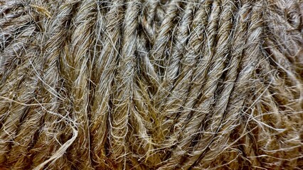 close-up of rough natural jute rope texture with detailed fibrous strands for rustic craft or packaging design background

