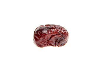Isolated dried cranberry against a white background, highlighting a single berry in macro detail