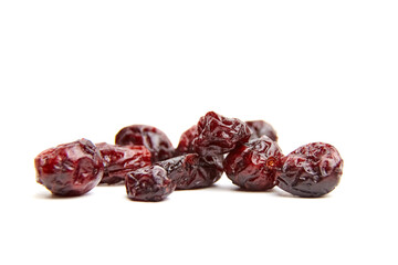 Dried cranberries arranged on a white background, showcasing their rich color and texture, perfect...