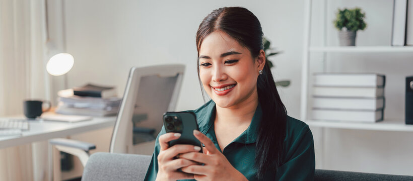 Asian Woman Using Smartphone for Online Shopping Social Media Connection Remote Work or Communication at Home