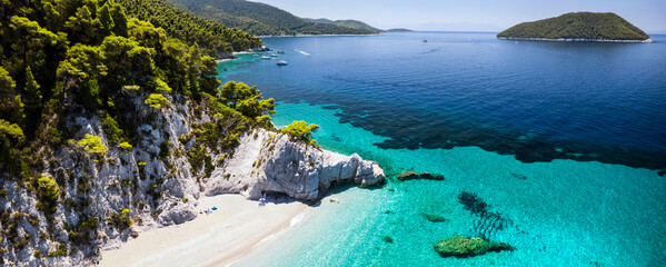 Best beaches of Greece. Sporades. Beautiful Skopelos island - Hovolos beach (near Neo klima village) with turquoise crystal sea surrounded by green hills. aerial drone view