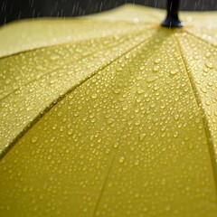 Close-up view of water droplets on a yellow umbrella.