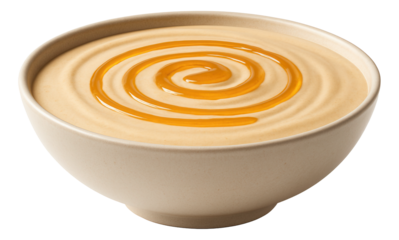 Creamy peanut butter in a bowl with a swirl of golden honey on top.