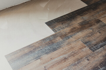 Installing vinyl wood planks over concrete subfloor during home renovation