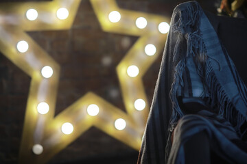 Cozy Blanket and Glowing Star Lights in Rustic Setting for Holiday Decor Inspiration