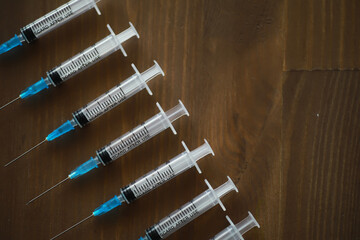 Medical Syringes on Wooden Surface - Healthcare, Vaccination, Injection, Medicine, Clinic