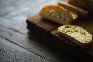 Sliced Bread on Wooden Cutting Board Close-up on Rustic Dining Table