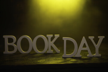 Book Day Celebration - Yellow Spotlight on Wooden Background