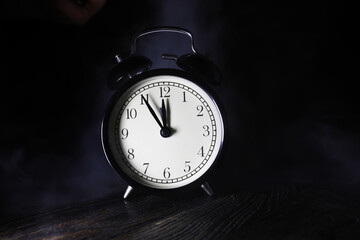 Vintage Black Alarm Clock Showing Midnight Conceptualizing Time and Punctuality