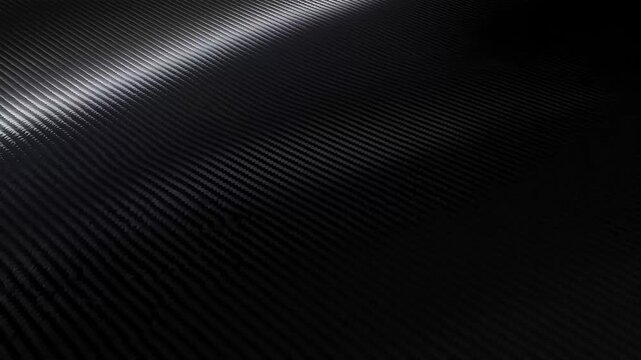 Dark carbon fiber surface with diagonal weave pattern, showcasing strength and modern design, ideal for automotive
