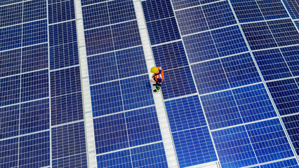 Solar panel technician working on photovoltaic installation in sunny weather