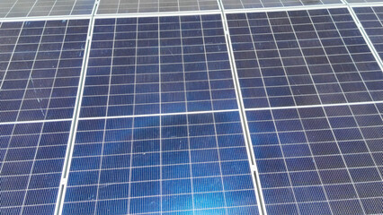 Solar panels capture sunlight on a rooftop in a clear blue sky