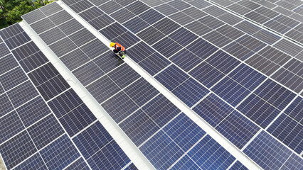 Workers maintain solar panels on a rooftop in a sustainable energy project