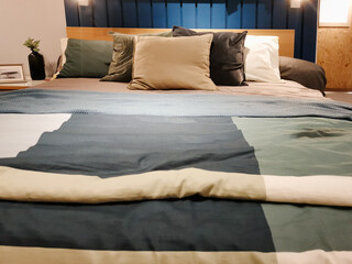 Cozy bedroom with plush pillows, soft bedding, and elegant decor in a modern home setting