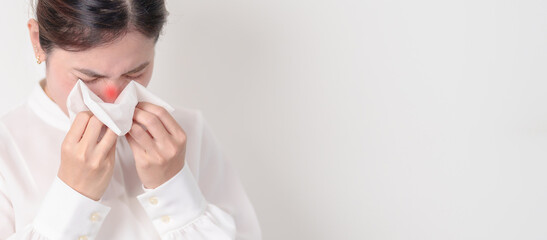 business woman blowing her nose with tissue for concepts of Common Cold, Influenza, Flu, Hay, Fever, Covid 19, Respiratory Infection, Sinusitis, Allergic Rhinitis, Allergy, Medical and health care