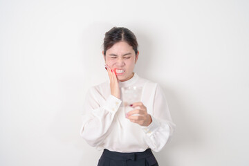Business woman having toothache and pain after drink ice water for concept of Teeth Sensitive to...