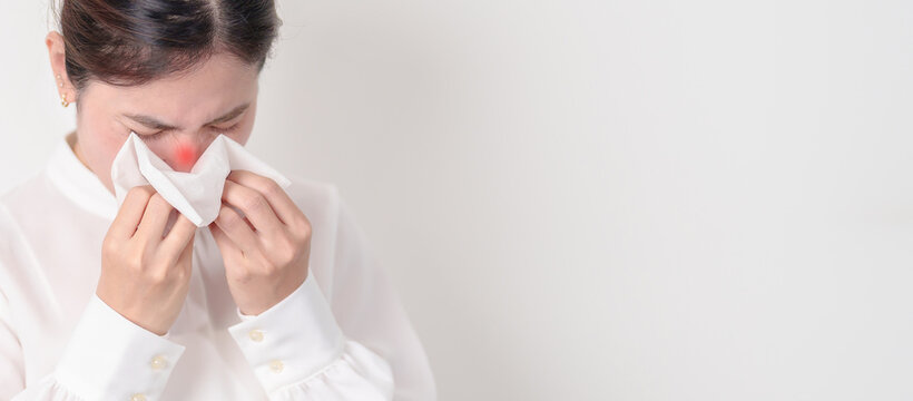 business woman blowing her nose with tissue for concepts of Common Cold, Influenza, Flu, Hay, Fever, Covid 19, Respiratory Infection, Sinusitis, Allergic Rhinitis, Allergy, Medical and health care