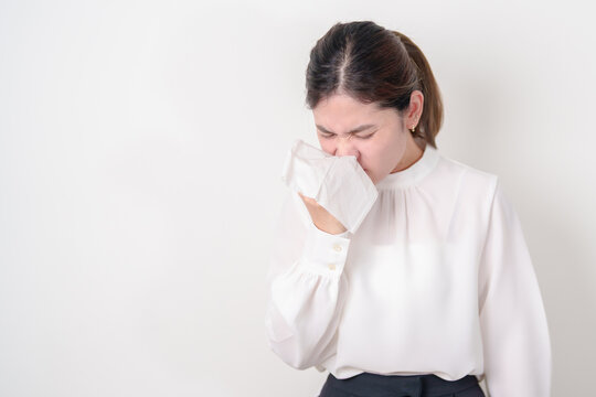 business woman blowing her nose with tissue for concepts of Common Cold, Influenza, Flu, Hay, Fever, Covid 19, Respiratory Infection, Sinusitis, Allergic Rhinitis, Allergy, Medical and health care
