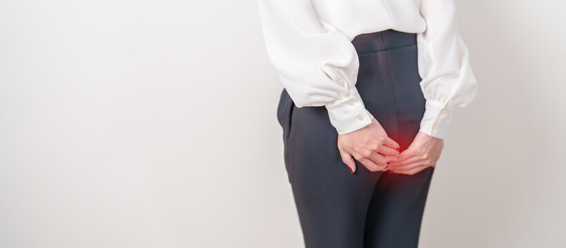 Business Woman having Anal symptoms pain for Hemorrhoids disease, Constipation, Anal cancer awareness month, diarrhea, Irritable Bowel Syndrome, IBS, Inflammation, Colorectal cancer and Anal Procttis