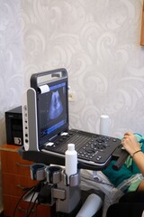 Medical Ultrasound Imaging System: Showing a sonogram image, keyboard and mounted on a cart in...