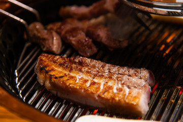 roasting pork on the charcoal grill